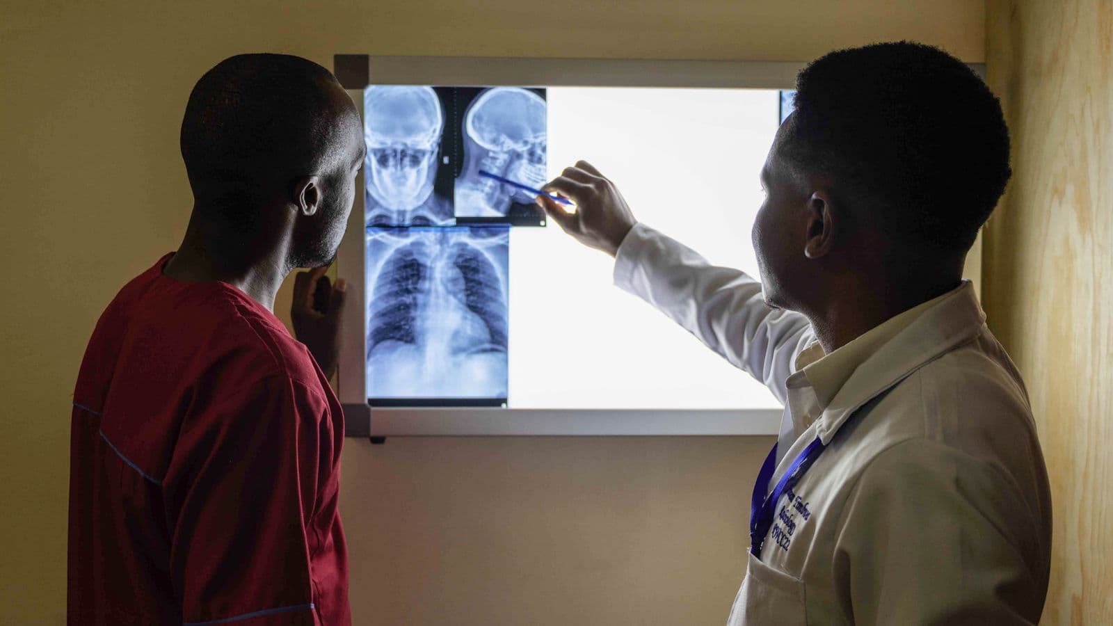 A doctor in Kenya goes over X-ray results with a patient during a hospital consultation.