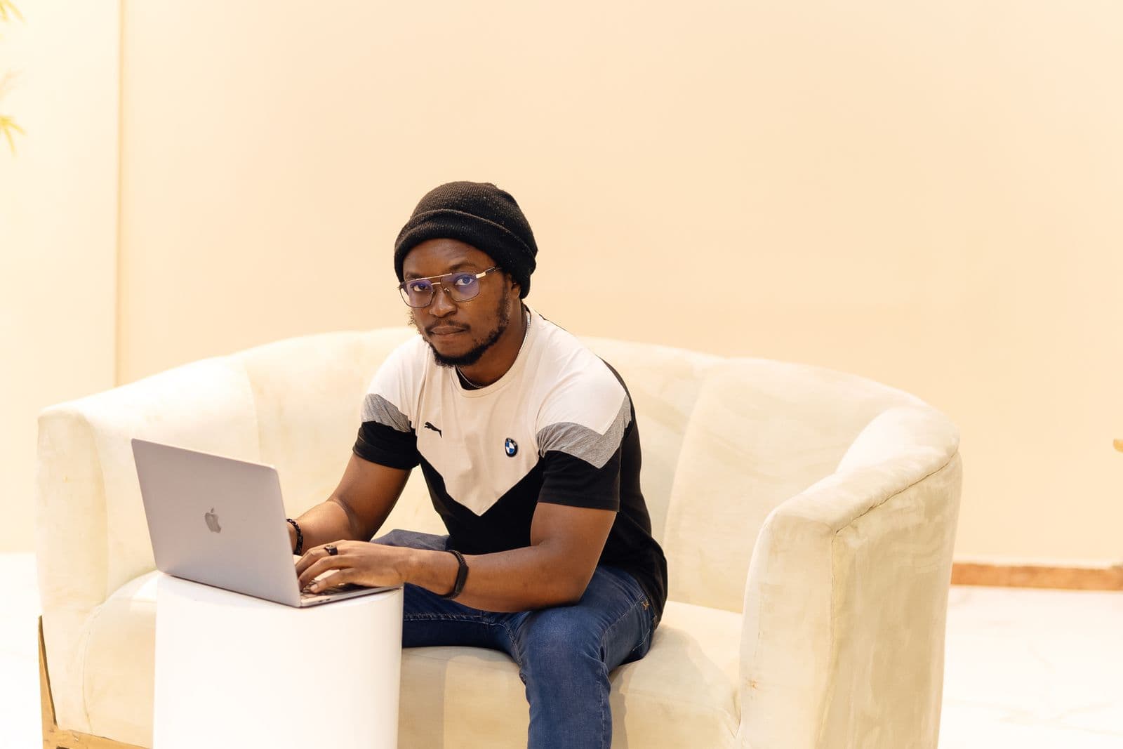 A freelancer working on a laptop in a home setting in Lagos, Nigeria