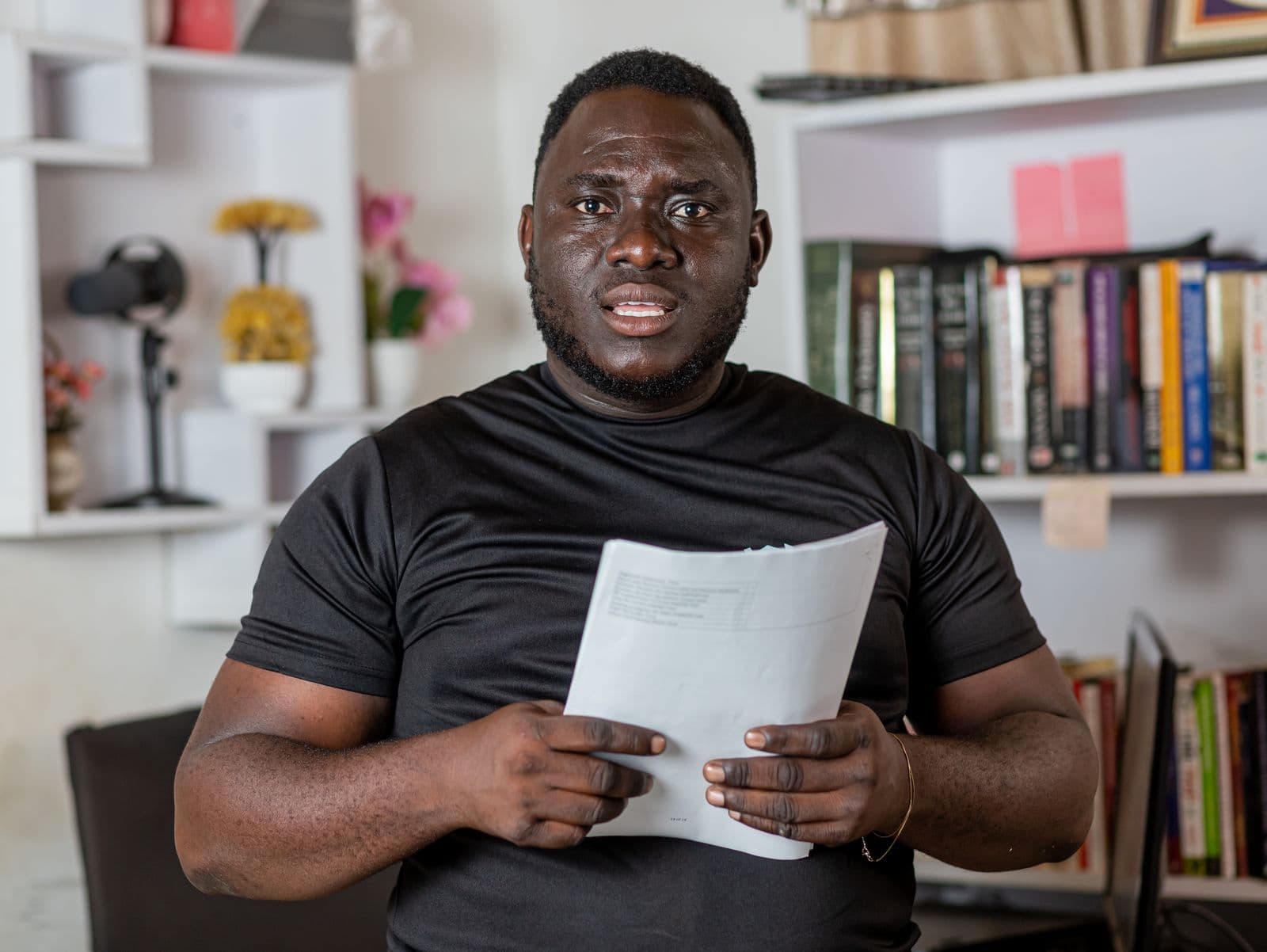 A man in Kenya reviewing a land title document