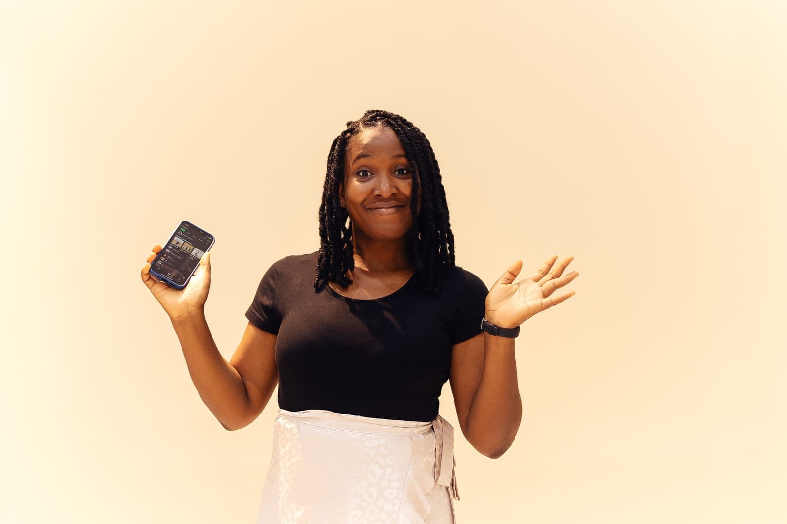 A Nigerian woman in Lagos smiles while holding her smartphone to check her OPay account