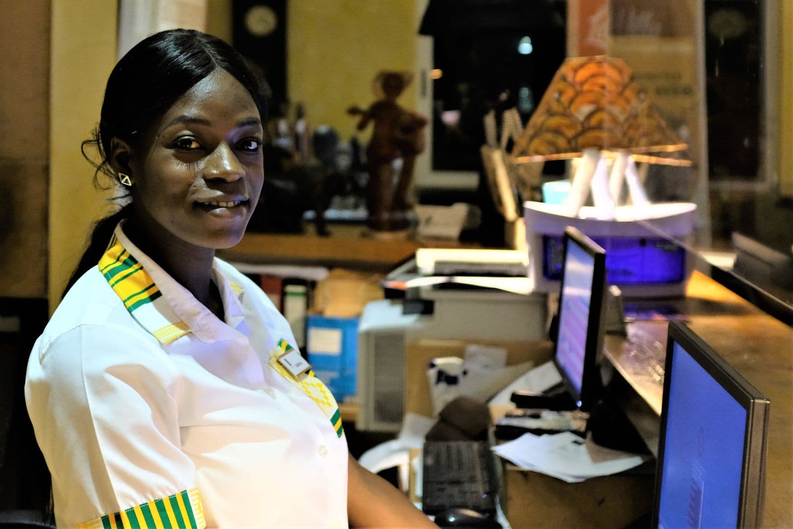 A salaried worker at her desk in Accra, Ghana, whose monthly pay is subject to PAYE deductions