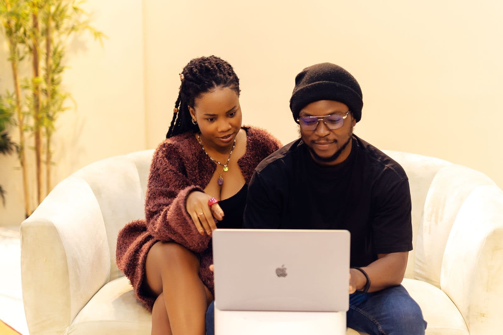 A small business owner in Lagos, Nigeria filing tax returns online on a laptop to apply for a Tax Clearance Certificate