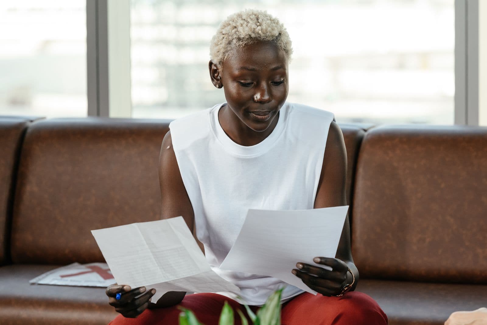 A woman comparing retirement annuity documents and provider quotes at a desk