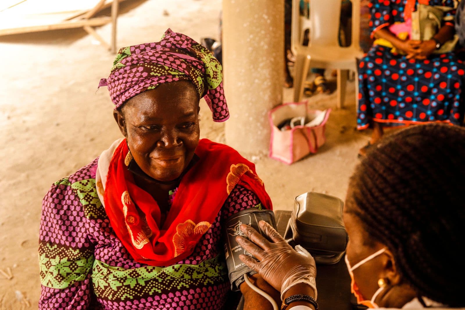 A woman having her blood pressure checked during an out-patient consultation at a clinic in Ghana, the kind of visit NHIS covers