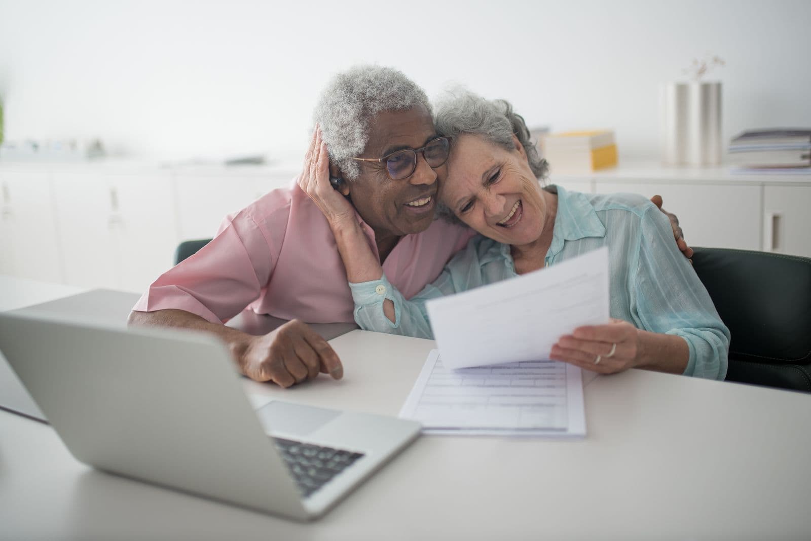 Older couple reviewing pension documents together at a desk