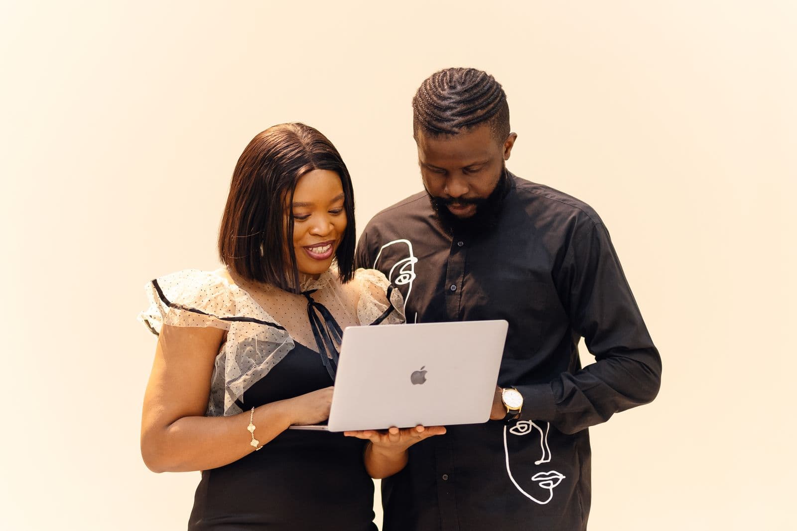Two Lagos office workers reviewing tax filing details on a laptop