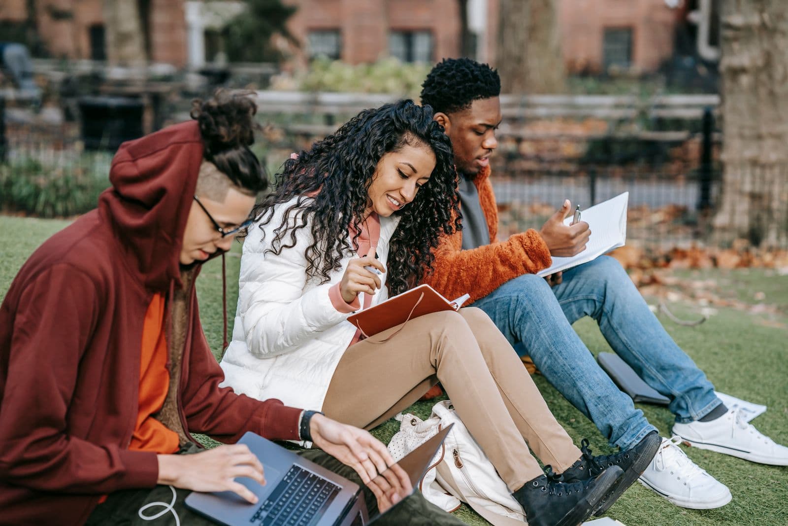 University students working together on laptops outdoors