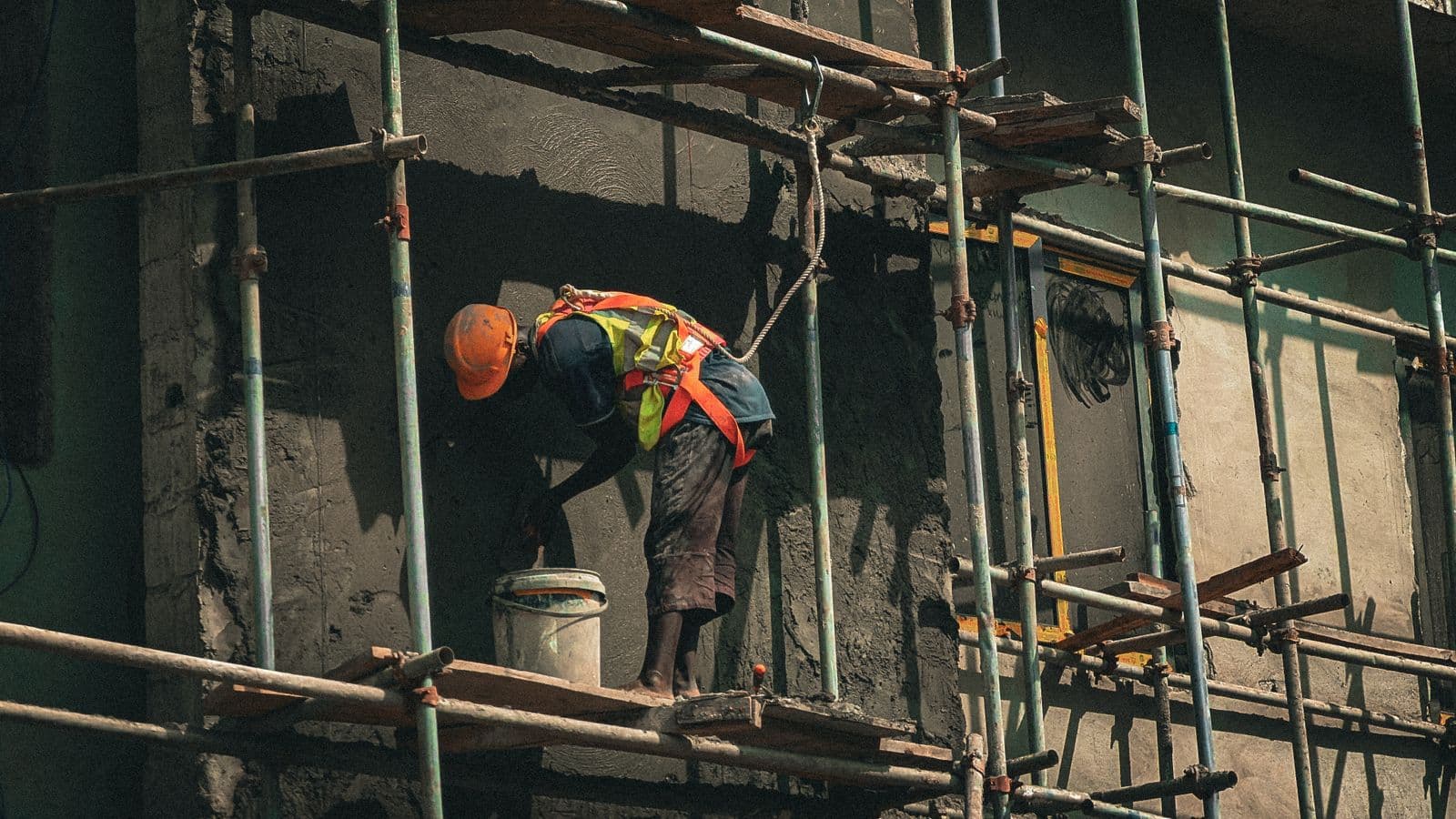 A construction worker plastering a building wall